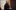 2019-Theatreworks-darkcardigan-EllieKurttz-2000x1250 A person standing and smiling, wearing a dark cardigan