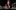 2022JekyllHyde-lab A production image from 'Jekyll and Hyde' on a schools tour in 2022 featuring a woman dressed in Victorian clothing leaning over a laboratory table topped by glass beakers