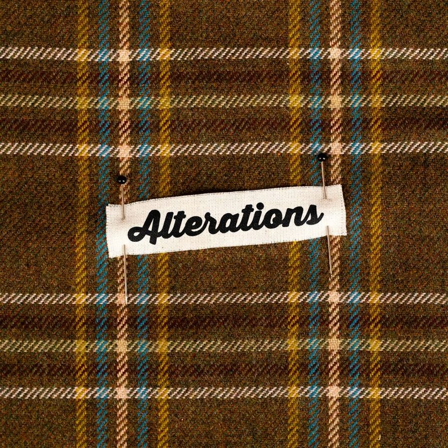 Alterations-National-Theatre-masthead-v1 A white fabric label with the word