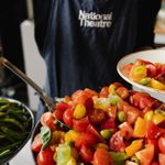 Tomatoe oand olive salad being served on a plate.