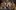 2018-BarbershopChronicles A production image from 'Barber Shop Chronicles' at the Dorfman Theatre, 2018, featuring a group of Black men all watching something with excited and shocked faces