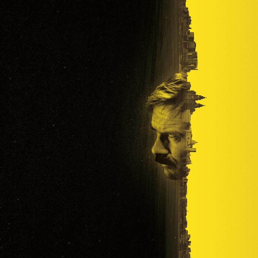 Boys-From-the-Blackstuff-National-Theatre-2000x1000 A rectangle, three quarters black and one quarter yellow, and on the vertical line where these meet, an image of the Liverpool docks skyline, including the Liver Building, is rotated 90 degrees clockwise, against which, the face of a man is looking into the black area of the rectangle.