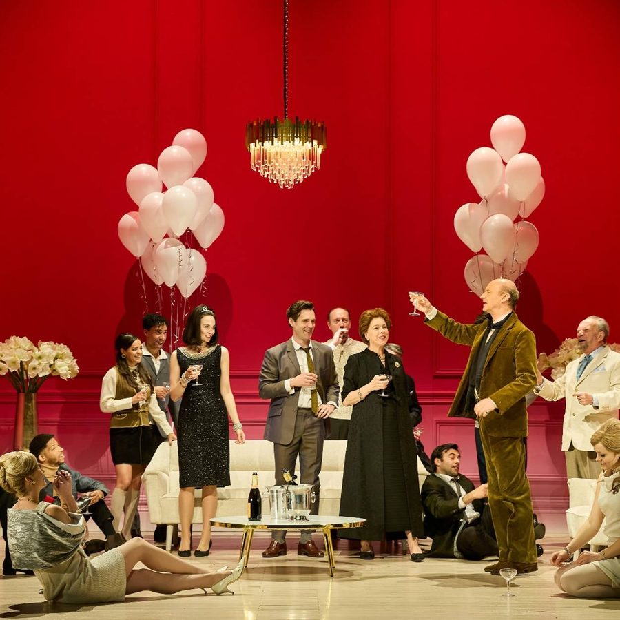 company-the-motive-and-the-cue-national-theatre-photo-mark-douet-aspect-ratio-2000-1000 Mark Gatiss makes a toast to a room full of smiling people at a party.