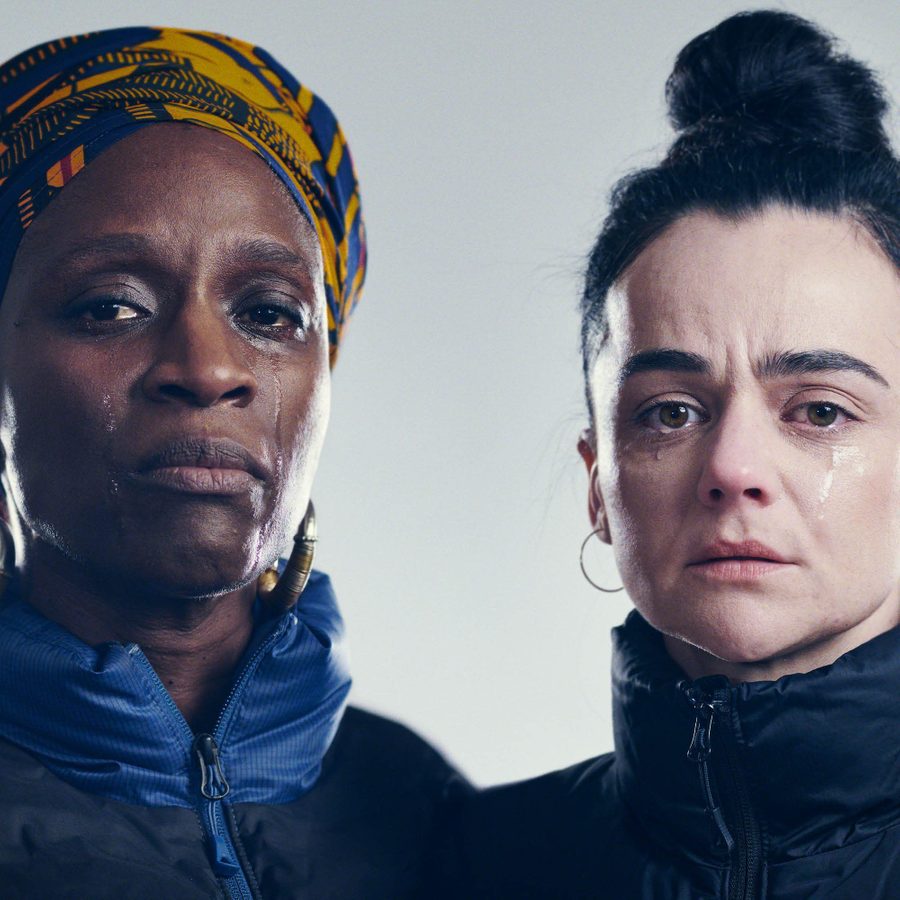 Death-of-England-Closing-Time-National-Theatre-2000x1000 A close-up of the faces of two women, both looking sad, with tears in their eyes and rolling down their cheeks.