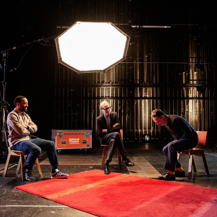 Life-in-stages-Bill-Nighy-Chiwetel-Ejiofor-Andrew-Lincoln Three men sitting on chairs on a bare stage under a large whte light