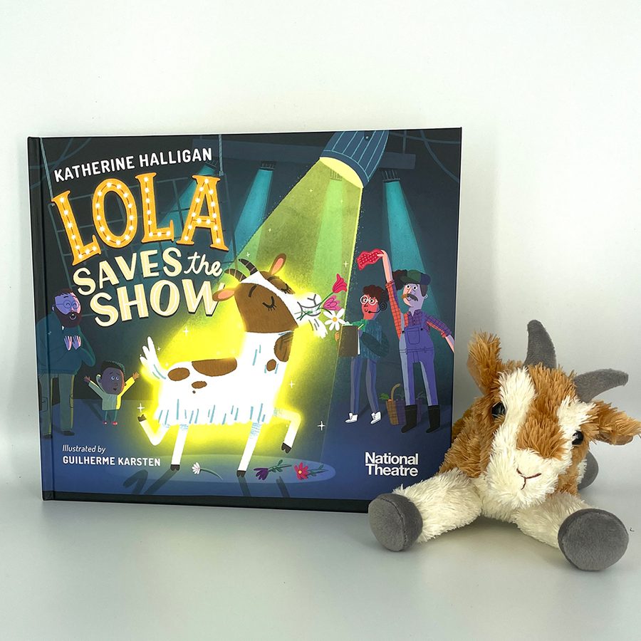 Lola-saves-the-show-2000x1000-masthead-bookshop-childrens-picture-book The children's picture book 'Lola saves the show' sitting on a grey table, with a cuddly toy of a goat sitting next to it.