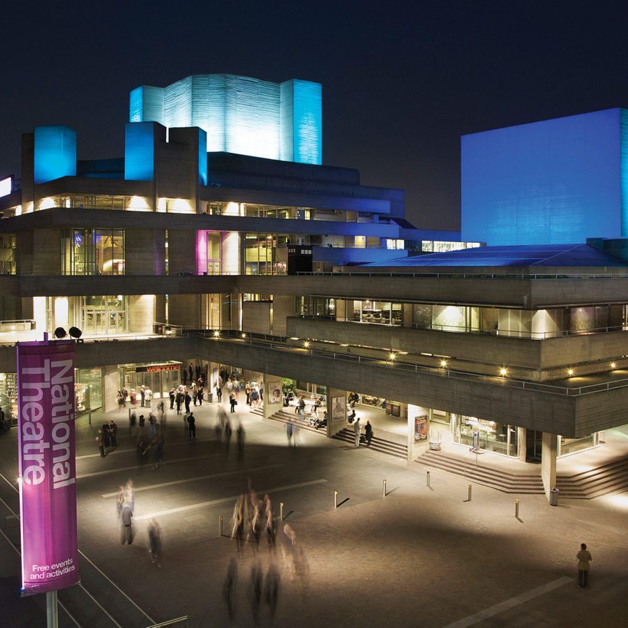National-Theatre-Exterior-at-night-2000x1000-masthead-Paul-Greenleaf The exterior of the National Theatre at night, with the flytowers lit up in blue light.