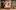 Neil McDermott and Jessica Ransom are sitting on one end of a small sofa, looking at Cassie Bradley, who sits on the other end of the sofa, looking intently at Matthew Douglas, who knees on the floor and looks earnestly at her.