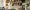 nt-wigs-hair-and-make-up-1280x640 A person arranges wigs on a shelf in a room filled with various wig mannequins, styling heads, and hairpieces. The workspace is filled with styling tools, bottles, and hair products, creating a busy, organized environment.