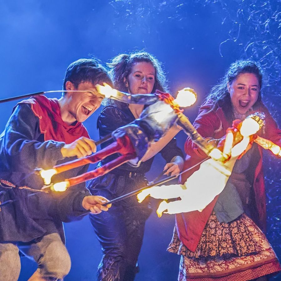 Ocean-at-the-End-of-the-Lane-Puppets-2000x1000-Brinkhoff-Moegenburg Domonic Ramsden and Keir Oglivy (Boy), operating two illuminated stick puppets, as Aimee McGolderick and Millie Hikasa (Lettie) look on, laughing