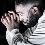 Paapa Essiedu as Tristan in The Effect. He is wearing a white hoodie, and looking to the left.