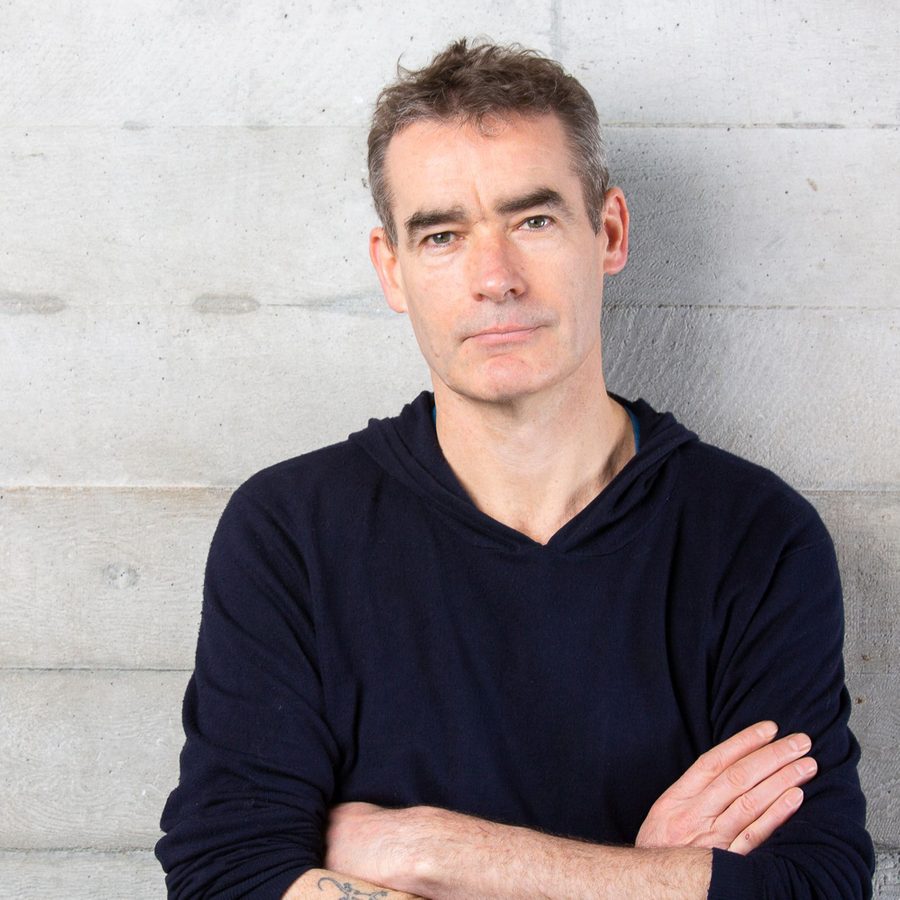 Rufus-norris-2000x1000-masthead-blog-photo-ellie-kurttz Rufus Norris stands next to the famous concreate walls of the national theatre.